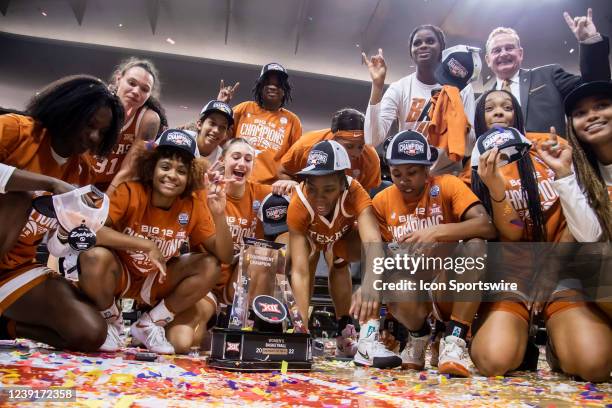 The Texas Womens Basketball team celebrate with the Championship trophy after their victory over the Baylor Bears during the Big12 Womens...