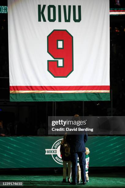 Former Minnesota Wild player Mikko Koivu watches with his family as a banner is raised during his number retirement ceremony before the start of the...