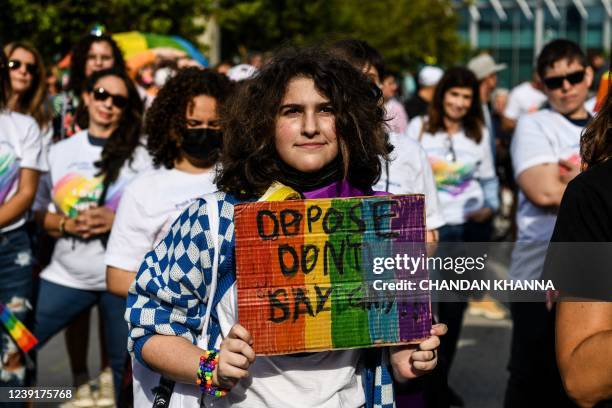 Members and supporters of the LGBTQ community attend the "Say Gay Anyway" rally in Miami Beach, Florida on March 13, 2022. - Florida's state senate...