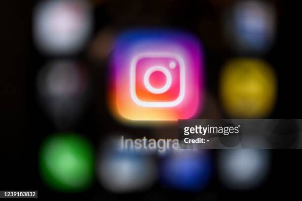 Photo taken on March 14 shows the US social network Instagram logo on a smartphone screen in Moscow. - Instagram was inaccessible in Russia on March...