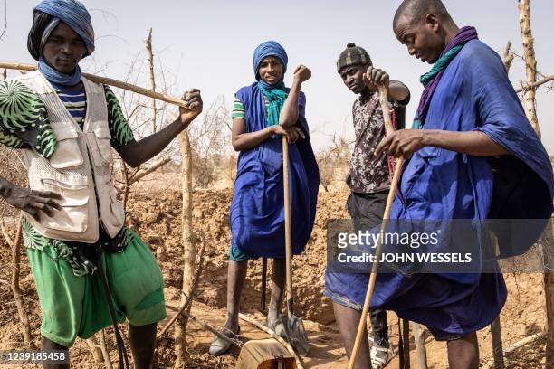 Fulani herdsmen rest after digging a makeshift water well on the outskirts of the village of Madina Torobe, Matam Region on March 11, 2022. - Some...