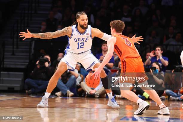 Duke Blue Devils forward Theo John defends against Virginia Tech Hokies guard Sean Pedulla during the first half of the ACC Tournament final college...