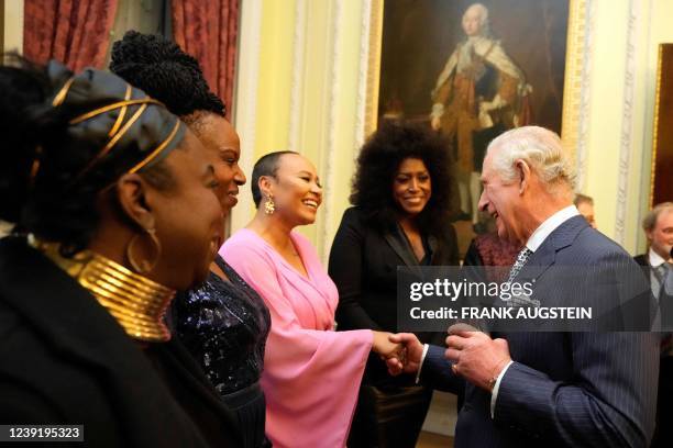 Britain's Prince Charles, Prince of Wales shakes hands with British singer-songwriter Emeli Sande during the Commonwealth Day reception at...