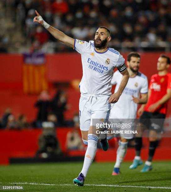 Real Madrid's French forward Karim Benzema celebrates after scoring a goal during the Spanish League football match between RCD Mallorca and Real...