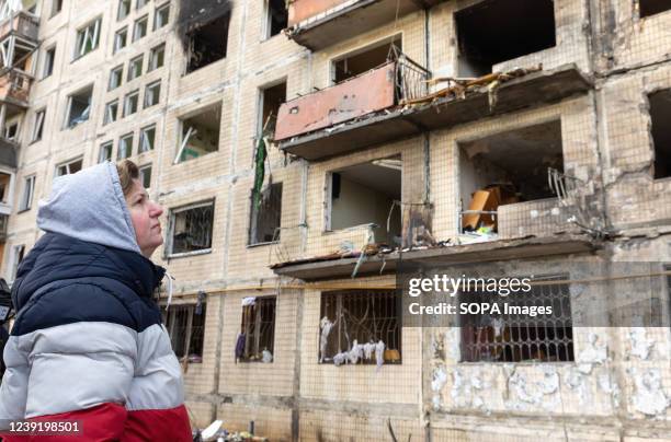 Resident looks at the badly damaged residential building that was hit by a Russian shell. Russian forces continue their full scale invasion in...