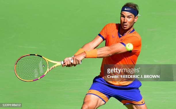 Rafael Nadal of Spain hits a backhand return to Daniel Evans of Britain during their round 3 match at the Indian Wells tennis tournament on March 14,...