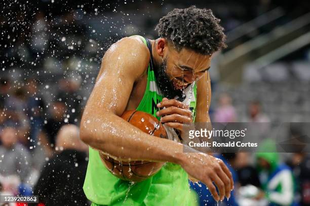Karl-Anthony Towns of the Minnesota Timberwolves gets a water bath after scoring sixty points against the San Antonio Spurs at AT&T Center on March...