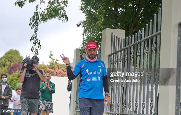 Mosque shooting survivor Temel Atacocugu reacts during his walk for peace on March 15, 2022 in Christchurch, New Zealand. Mosque shooting survivor...