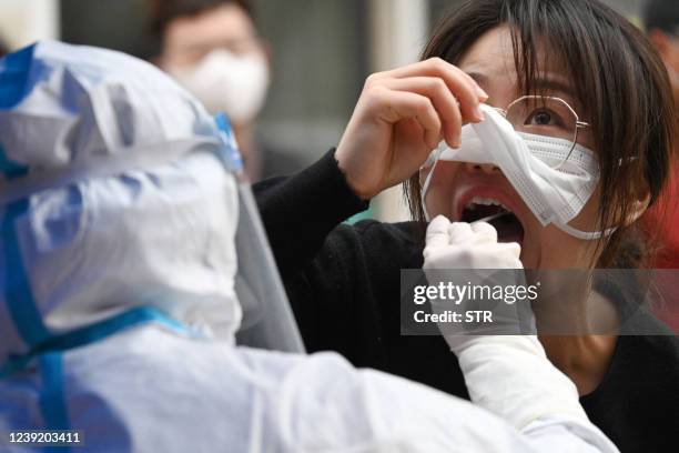 Resident undergoes a nucleic acid test for the Covid-19 coronavirus in Handan in China's northern Hebei province on March 15, 2022. - China OUT /...