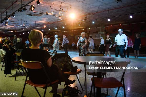Elderly people dance on a thursday afternoon at the "Roaljorero dancing" in Monteux, southeastern France on March 3, 2022. - This nightclub, is one...