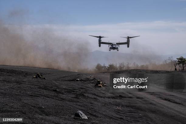 United States Marine Corp Osprey lands next to prone soldiers from Japans 1st Amphibious Rapid Deployment Brigade during an exercise with the United...