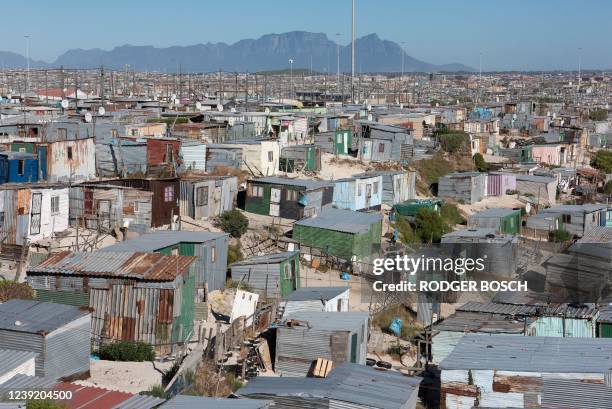 General view of informal settlements and other parts of Khayelitsha, home to millions of people in mostly impoverished circumstances, with the back...