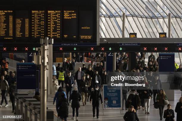 Commuters make their way along a railway concourse after arriving at London Waterloo railway station, in London, U.K. On Monday, March 14, 2022. U.K....