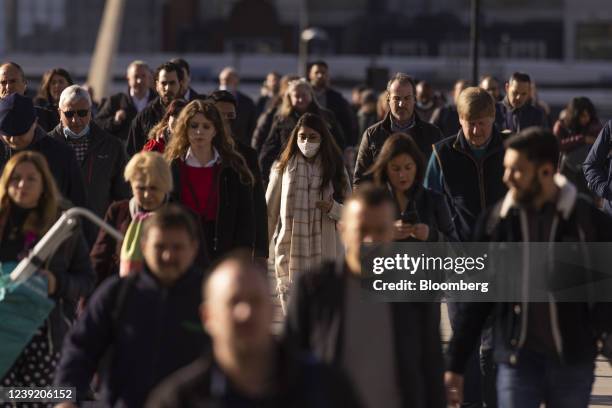 Morning commuters cross London Bridge in the City of London, U.K. On Monday, March 14, 2022. U.K. Unemployment dropped below its pre-pandemic level...