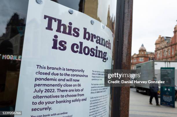 Notice on display in the window of a closed branch of NatWest, a popular British high street bank, informs the public of the reasons for its closure...