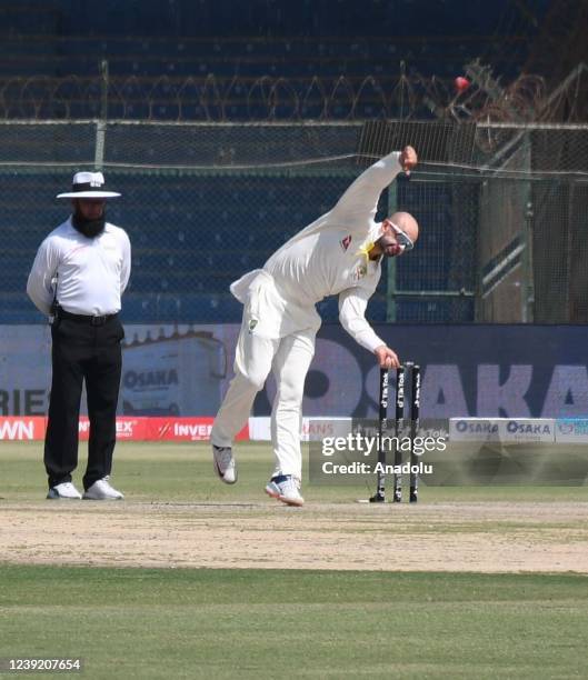 Australia's Nathan Lyon bowls during the fourth day of the second test match between Pakistan and Australia at the National Stadium in Karachi...