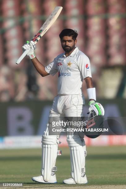 Pakistan's captain Babar Azam celebrates after scoring a century during the fourth day of the second Test cricket match between Pakistan and...