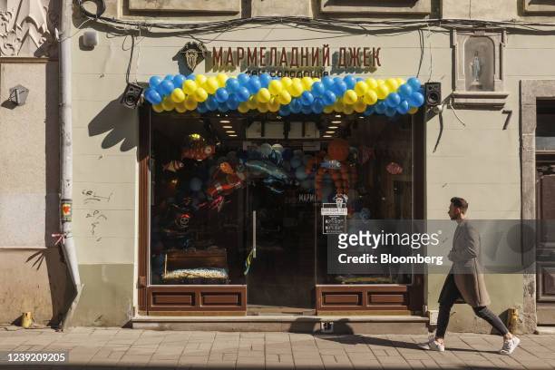 Balloons in colors of the Ukrainian national flag adorn the front of a shop in Lviv, Ukraine on Monday, March 14, 2022. Shelling continued overnight...