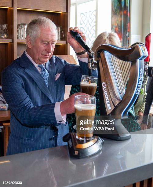 Prince Charles, Prince of Wales pours a pint of Guinness during a visit to The Irish Cultural Centre on March 15, 2022 in London, England. The Prince...