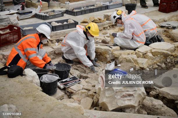 Archaeologists excavate the floor of Notre Dame Cathedral after the discovery of a 14th century lead sarcophagus, in Paris, on March 15, 2022.