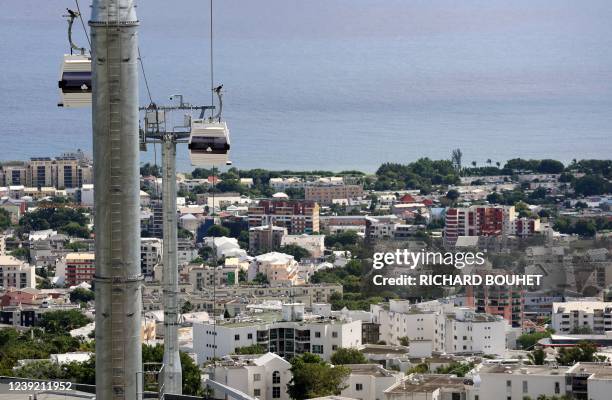 This photograph taken on March 15 shows two cabins of the first urban cable car on the Indian Ocean island of Reunion, on the day of its inauguration...