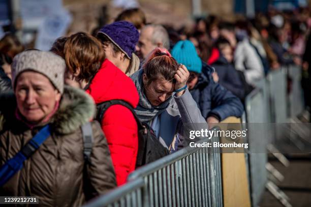 Displaced Ukrainians wait in line at the Medyka border crossing in Medyka, Poland, on Tuesday, March 15, 2022. At least 2.5 million Ukrainians are...