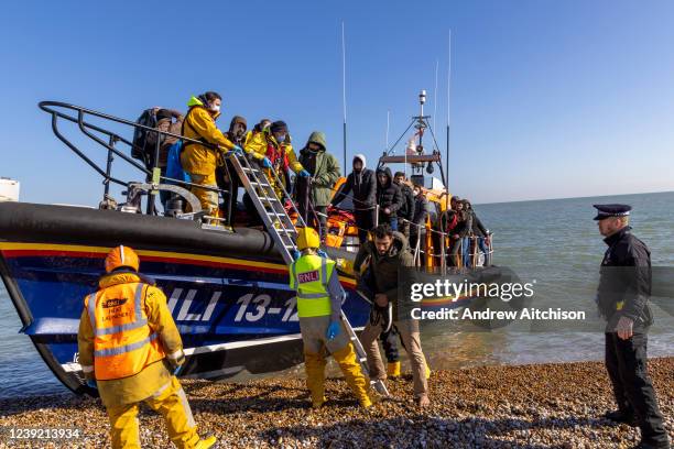 Dungeness RNLI is met by launch staff and police as it arrives into shore at Dungeness after collecting 43 people including women and 10 children...