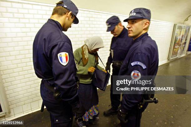 Des policiers du Service régional de la Police des transports effectuent, le 08 octobre 2003, un contrôle d'identité sur une jeune femme dans le...