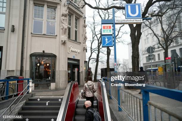 Commuters use an escalator from a metro station in Hamburg, Germany, on Tuesday, March 15, 2022. Despite soaring infections, Germany is sticking with...