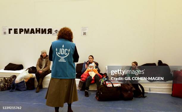 Member of global Jewish humanitarian organisation JDC walks as Ukrainian Jewish refugees who fled the war in their country wait inside a gymnasium in...