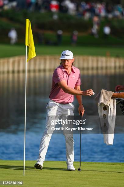 Cameron Smith of Australia puts his ball in his Presidents Cup International Team towel on the 18th hole green during the final round of THE PLAYERS...