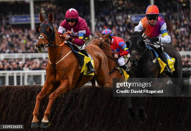 Gloucestershire , United Kingdom - 15 March 2022; Run Wild Fred, with Jamie Codd up, left, and Beatthebullett, with James King up, jump in the...