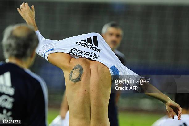 Tattoo is seen on Argentine footballer Lionel Messi's back following a training session at the Bangabandhu National Stadium in Dhaka on September 5,...