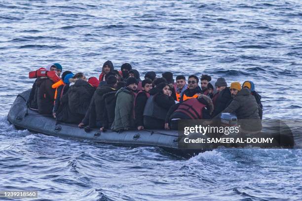 Migrants sits in a dinghy illegally crossing the English Channel from France to Britain on March 15, 2022.