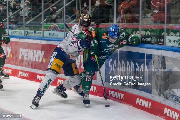Marco Bassler of Eisbären Berlin and Blaz Gregorc of Augsburger Panther battle for the puck during the Penny DEL match between Ausgburger Panther and...