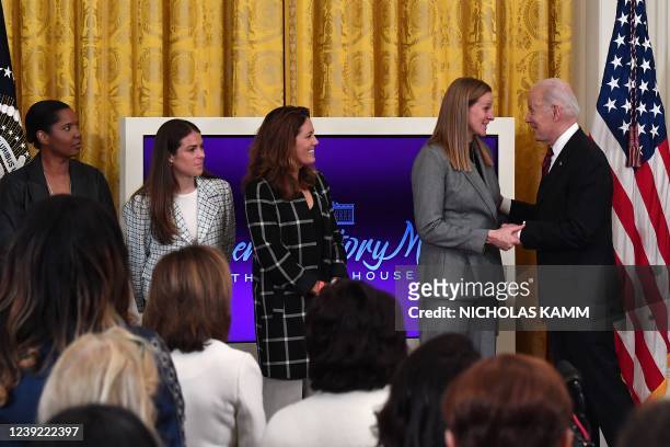 President Joe Biden greets Cindy Parlow Cone, president of the US Soccer Federation, and Briana Scurry, former member of the US Women's National...
