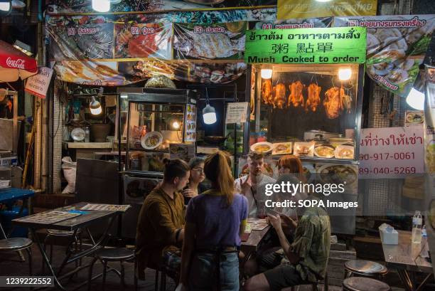 Tourists seen ordering food at a restaurant in Bangkok's Chinatown. Chinatown also known as Yaowarat is the famous destination for tourists in the...