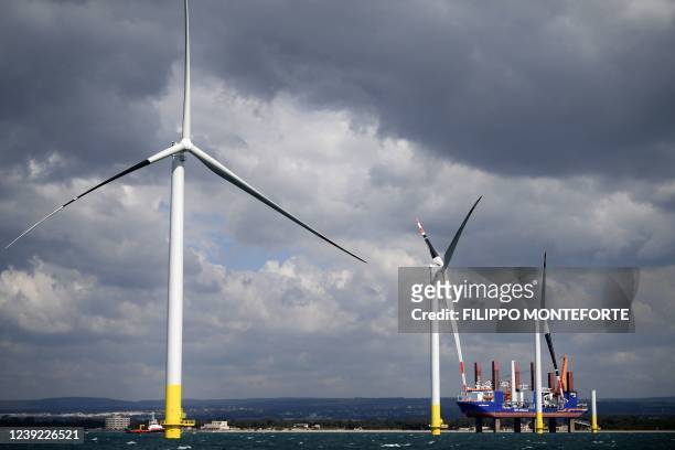 Wind turbines are pictured during their assembly at the Taranto offshore wind turbines farm on March 10, 2022 in Taranto, southern Italy. - The...