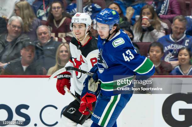 Brothers Vancouver Canucks defenseman Quinn Hughes and New Jersey Devils center Jack Hughes skates up ice during their NHL game at Rogers Arena on...