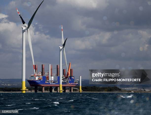 Wind turbines are pictured during their assembly at the Taranto offshore wind turbines farm on March 10, 2022 in Taranto, southern Italy. - The...