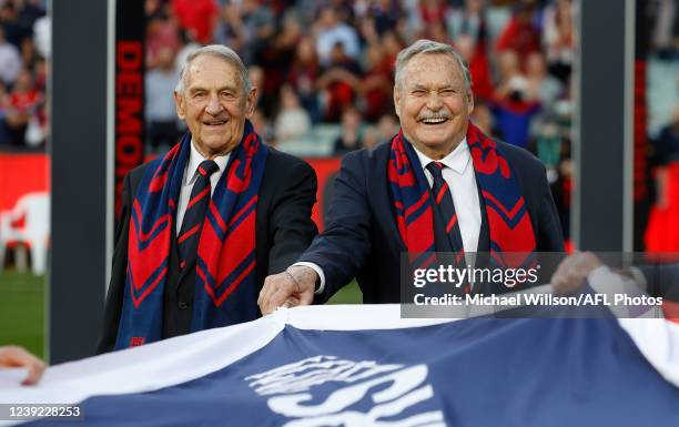 Hassa Mann and Ron Barassi carry Melbourne's 2021 Premiership Flag during the 2022 AFL Round 01 match between the Melbourne Demons and the Western...