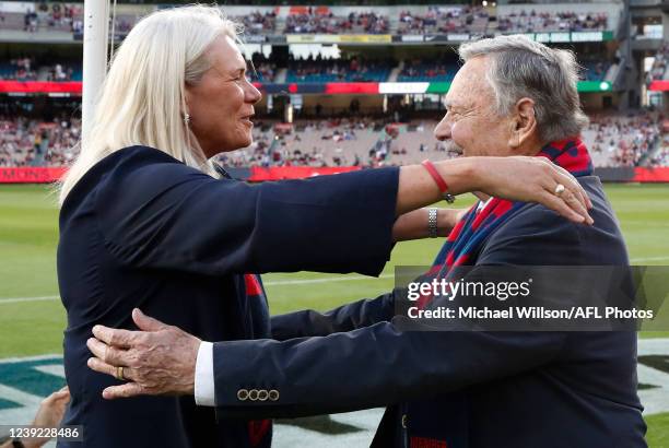 Kate Roffey and Ron Barassi embrace after unfurling Melbourne's 2021 Premiership Flag during the 2022 AFL Round 01 match between the Melbourne Demons...