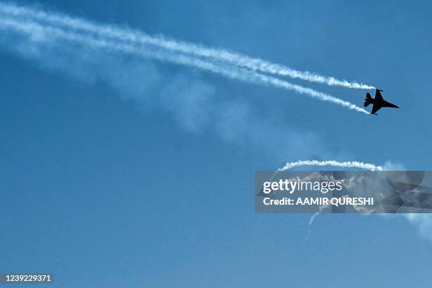 Pakistan Air Force F-16 fighter jet performs maneuvers during a rehearsal ahead of Pakistan's Day parade on March 23, in Islamabad on March 16, 2022.