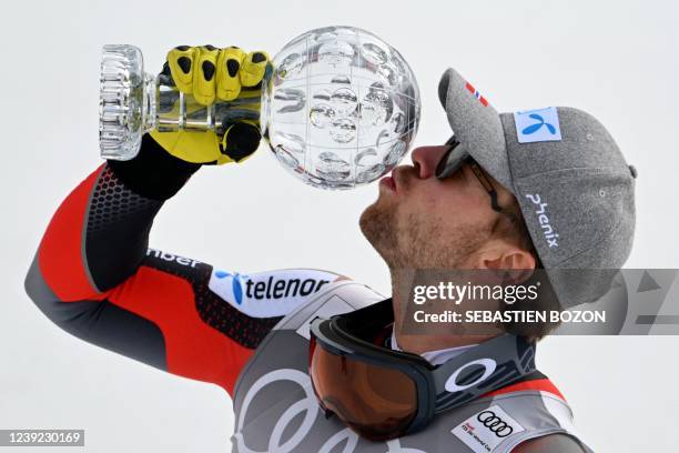 Norway's Aleksander Aamodt Kilde celebrates with the small globe for the men's downhill season champion at the FIS Alpine Ski World Cup finals...