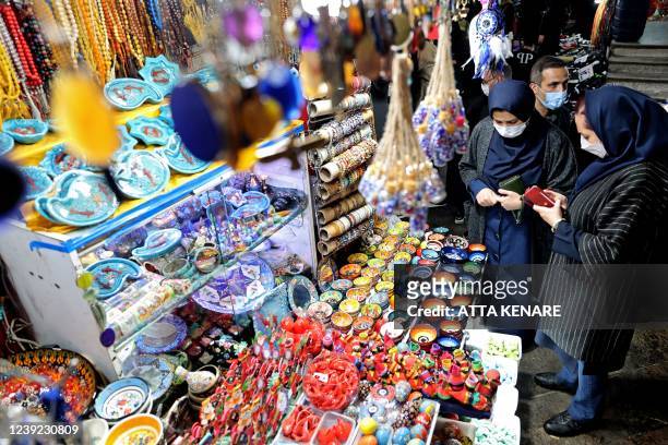 Iranians shop at the Tajrish Bazaar market in the capital Tehran on March 16 in preparation for the celebration of Noruz, the Persian New Year. -...