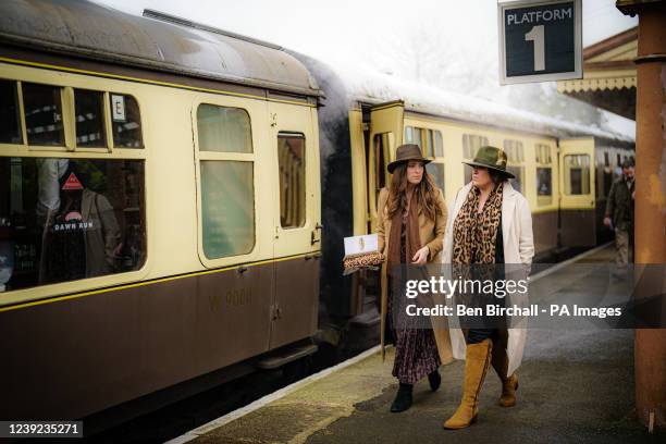 Women make their way along the platform at Toddington station, where the special heritage steam express train service is taking race goers to the...