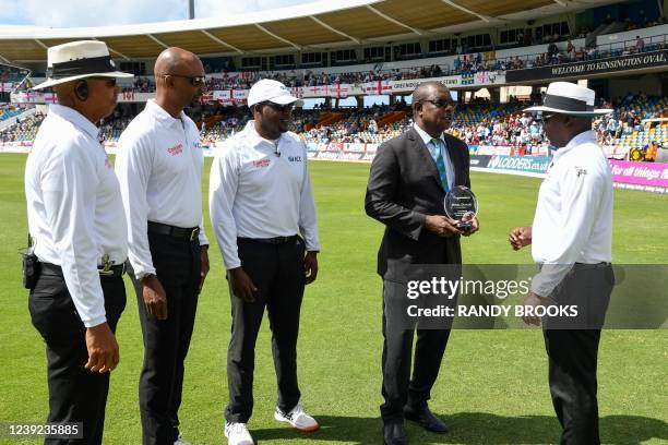Match referee Sir Richie Richardson presents umpire Nigel Duguid with a plaque on debut as Joel Wilson , Gregory Brathwaite and Leslie Reifer look on...
