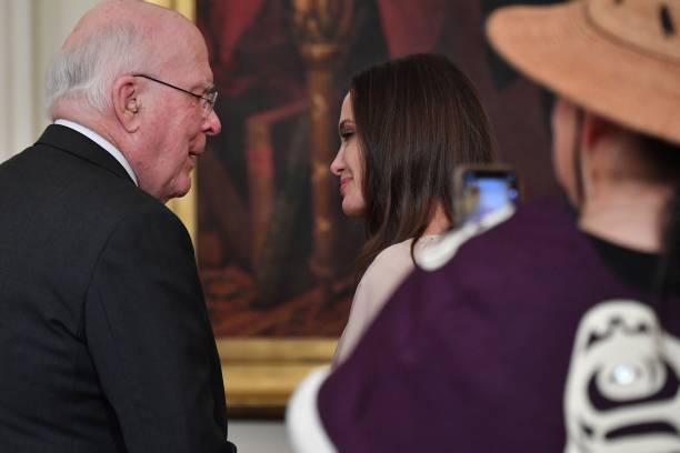 Senator Patrick Leahy speaks to US actress Angelina Jolie prior to an event celebrating the reauthorization of the Violence Against Women Act, in the...