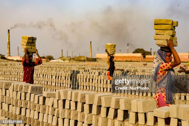 Workers are working at a brickyard in Dhaka, Bangladesh on March 16, 2022.