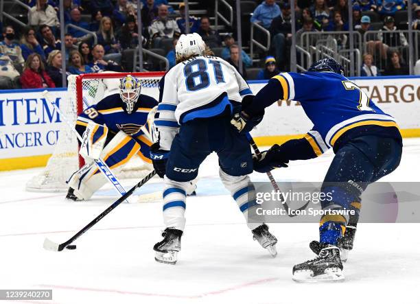 Winnipeg Jets leftwing Kyle Conner sets up a shot on goal against St. Louis Blues goaltender Jordan Binnington during an NHL game between the...